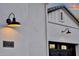 Exterior features stylish lighting, house number 1073, and dark painted garage doors at 1160 E Peach Tree Dr, Chandler, AZ 85249