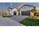 An attractive home featuring dual garages, lush green grass, and a beautifully paved driveway at 1160 E Peach Tree Dr, Chandler, AZ 85249
