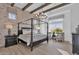 Elegant main bedroom boasts a four-poster bed, brick accent wall, and wood-look tile flooring at 1160 E Peach Tree Dr, Chandler, AZ 85249
