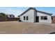 Spacious backyard with gravel, a small patch of grass, and a charming brick paver patio at 1225 N 159Th Ln, Goodyear, AZ 85338