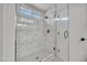 Bathroom featuring marble tiled walk-in shower and glass doors at 1225 N 159Th Ln, Goodyear, AZ 85338