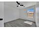 Bright bedroom with a ceiling fan, wood-look flooring, and a large window providing natural light at 1225 N 159Th Ln, Goodyear, AZ 85338