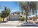 Charming single-story home with a well-manicured front yard and a two-car garage on a sunny day at 1225 N 159Th Ln, Goodyear, AZ 85338