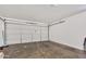 Clean and spacious garage with a smooth concrete floor and a modern, paneled garage door at 1225 N 159Th Ln, Goodyear, AZ 85338