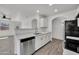 Updated kitchen showcasing stainless appliances and white cabinets at 1225 N 159Th Ln, Goodyear, AZ 85338