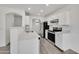 Bright kitchen with stainless steel appliances and white cabinets and countertops at 1225 N 159Th Ln, Goodyear, AZ 85338