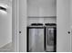 Convenient laundry room with modern washer and dryer units neatly tucked away behind closet doors at 1225 N 159Th Ln, Goodyear, AZ 85338