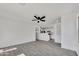 Bright, airy living room with gray wood-look tile flooring, white walls, ceiling fan, and open floorplan at 1225 N 159Th Ln, Goodyear, AZ 85338