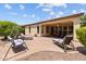 Spacious backyard with covered patio, lounge chairs, and attractive landscaping at 12945 W Yellow Bird Ln, Peoria, AZ 85383
