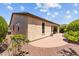 Beautiful backyard with brick patio, lush greenery, and desert landscaping at 12945 W Yellow Bird Ln, Peoria, AZ 85383