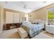Inviting bedroom with neutral tones, a comfortable queen bed and ample natural light at 12945 W Yellow Bird Ln, Peoria, AZ 85383