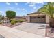 Inviting single-story home with a two-car garage and well-kept desert landscaping, creating an appealing curb presence at 12945 W Yellow Bird Ln, Peoria, AZ 85383