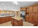 Spacious kitchen featuring stainless steel refrigerator, center island, and open layout at 12945 W Yellow Bird Ln, Peoria, AZ 85383