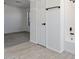 Bathroom features wood-look tile flooring, white tiled shower, and view into adjacent bedroom at 1510 W Fillmore St, Phoenix, AZ 85007