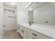 Bathroom featuring white cabinetry, quartz countertops, a large mirror, and wood-look tile floors at 1510 W Fillmore St, Phoenix, AZ 85007