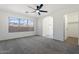 This bedroom features neutral carpet, a ceiling fan, and a door leading to the en suite bathroom at 1510 W Fillmore St, Phoenix, AZ 85007
