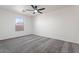 Vacant bedroom features neutral carpet, a ceiling fan, and a large window at 1510 W Fillmore St, Phoenix, AZ 85007