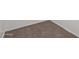 Close up view of clean and neutral carpet and new baseboards in a corner of a room at 1510 W Fillmore St, Phoenix, AZ 85007