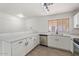 Bright kitchen features white cabinetry, quartz countertops, stainless steel appliances, and tile flooring at 1510 W Fillmore St, Phoenix, AZ 85007
