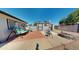 Backyard featuring a swing, a table and chairs, a shed, and a well-maintained patio and desert landscape at 1710 W 13Th Ave, Apache Junction, AZ 85120