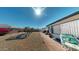 Expansive backyard featuring a landscaped area with a fountain, lush plants, and a cozy seating area at 1710 W 13Th Ave, Apache Junction, AZ 85120
