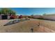 Large backyard featuring desert landscaping, stone accents, mature trees, and a cozy seating area at 1710 W 13Th Ave, Apache Junction, AZ 85120