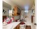 Functional bathroom featuring a single sink, a tub with shower curtain, and wall-mounted accessories for added convenience at 1710 W 13Th Ave, Apache Junction, AZ 85120