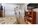 Neutral bedroom with white walls, carpet, butterfly decals, and a mounted TV, offering a clean and cozy atmosphere at 1710 W 13Th Ave, Apache Junction, AZ 85120