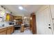 Charming kitchen area featuring wooden cabinets, tiled floors, and stainless steel appliances open to a dining area beyond at 1710 W 13Th Ave, Apache Junction, AZ 85120