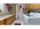Organized laundry area with wooden cabinets, a countertop, and a washing machine, offering practical space at 1710 W 13Th Ave, Apache Junction, AZ 85120