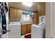 Practical laundry room with ample counter space, upper cabinetry, and both a front-load washing machine and a dryer at 1710 W 13Th Ave, Apache Junction, AZ 85120