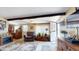 Inviting living room with dark wood beams, tile flooring, comfortable furnishings, and an electric fireplace at 1710 W 13Th Ave, Apache Junction, AZ 85120