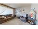 Cozy living room featuring a sofa, recliner, neutral decor, and large windows at 1710 W 13Th Ave, Apache Junction, AZ 85120