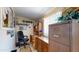 Cozy office space with a desk, chair, shelving, and lots of natural light streaming through the windows at 1710 W 13Th Ave, Apache Junction, AZ 85120