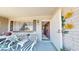 Cozy front porch with comfortable seating, decorative accents, and a welcoming entrance at 1710 W 13Th Ave, Apache Junction, AZ 85120