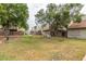 Townhome backyard with privacy walls, grassy areas, and lush trees at 222 W Brown Rd # 14, Mesa, AZ 85201