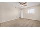 Bedroom with neutral walls, plush carpet, ceiling fan, and bright window at 222 W Brown Rd # 14, Mesa, AZ 85201