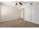 Bedroom with neutral walls, plush carpet, ceiling fan, and closet at 222 W Brown Rd # 14, Mesa, AZ 85201