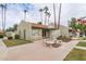 A community clubhouse with benches outside and landscaping, next to mature palm trees at 222 W Brown Rd # 14, Mesa, AZ 85201