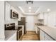 Modern kitchen with white cabinets, stainless steel appliances, and laminate wood flooring at 222 W Brown Rd # 14, Mesa, AZ 85201