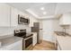 Well-lit kitchen features stainless steel appliances, light countertops, and white cabinets at 222 W Brown Rd # 14, Mesa, AZ 85201