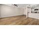 Spacious living area with wood flooring, fan, and open access to the kitchen at 222 W Brown Rd # 14, Mesa, AZ 85201