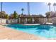 Inviting pool with clear blue water and a clubhouse featuring covered seating area nearby at 222 W Brown Rd # 14, Mesa, AZ 85201