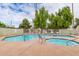 A refreshing community pool and spa area, surrounded by lush, mature trees at 222 W Brown Rd # 14, Mesa, AZ 85201