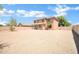 A spacious backyard featuring a two-story home with a covered patio and neutral gravel landscape at 2605 W Darrel Rd, Phoenix, AZ 85041