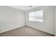 Clean and carpeted bedroom with a large window allowing ample natural light to flow through the space at 2605 W Darrel Rd, Phoenix, AZ 85041