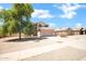 Two-story home with tan exterior, desert landscaping, driveway, and tile roof at 2605 W Darrel Rd, Phoenix, AZ 85041