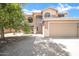 Home exterior with two stories, desert landscaping, tile roof, and a two-car garage at 2605 W Darrel Rd, Phoenix, AZ 85041