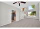 Neutral living room with high ceilings, a ceiling fan, carpet, and large windows at 2605 W Darrel Rd, Phoenix, AZ 85041