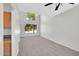 Neutral living room with high ceilings, a ceiling fan, carpet, and large windows at 2605 W Darrel Rd, Phoenix, AZ 85041